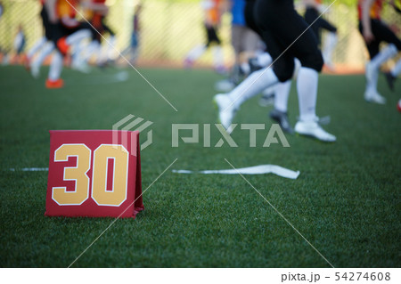 Image of soccer field with number thirty running football players on blurred background Image of soccer field with number thirty running football players on blurred background 54274608