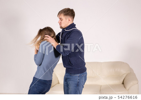 People, abuse and violence concept - aggressive man strangling his wife People, abuse and violence concept - aggressive man strangling his wife 54276616