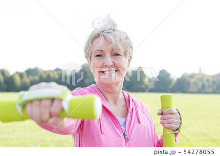 Active senior woman with dumbbells exercising Active senior woman with dumbbells exercising 54278055
