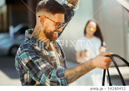 Young couple preparing for vacation trip on the car in sunny day 54280452