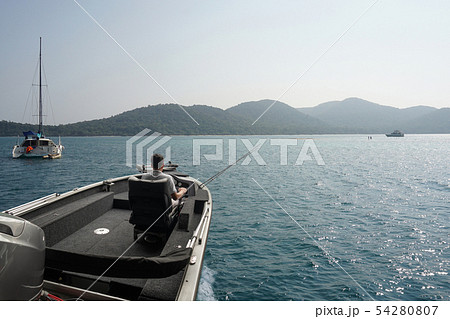 Fishing boat and fisherman in ocean Fishing boat and fisherman in ocean 54280807