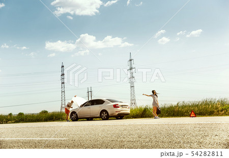 Young couple traveling on the car in sunny day 54282811
