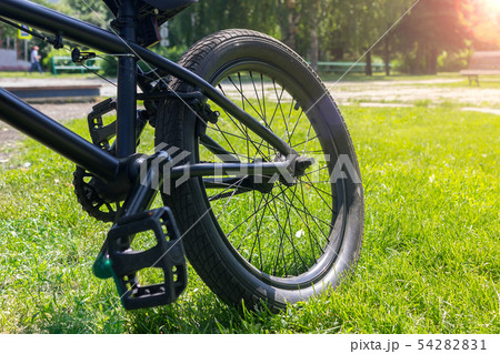 Bicycle rear wheel in bright sunshine Bicycle rear wheel in bright sunshine 54282831