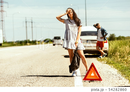 Young couple traveling on the car in sunny day Young couple traveling on the car in sunny day 54282860