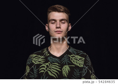 Close up portrait of young man isolated on black studio background 54284635