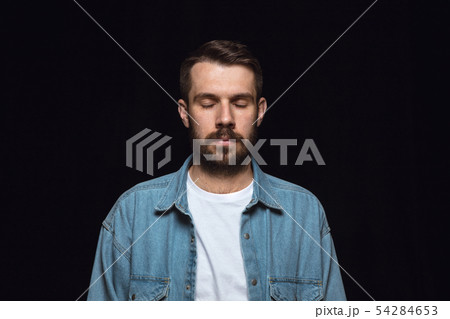 Close up portrait of young man isolated on black studio background 54284653
