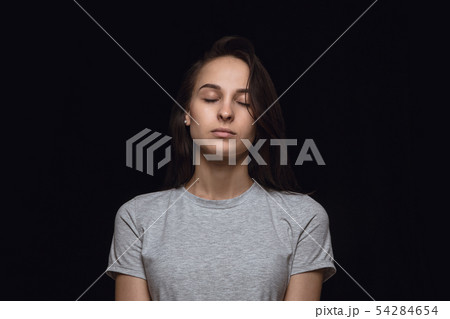 Close up portrait of young woman isolated on black studio background 54284654