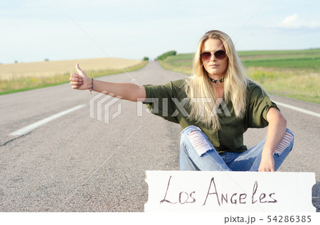 Beautiful Girl Hitchhiking On The Road Traveling. Beautiful Girl Hitchhiking On The Road Traveling. 54286385