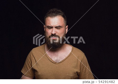 Close up portrait of young man isolated on black studio background Close up portrait of young man isolated on black studio background 54291482