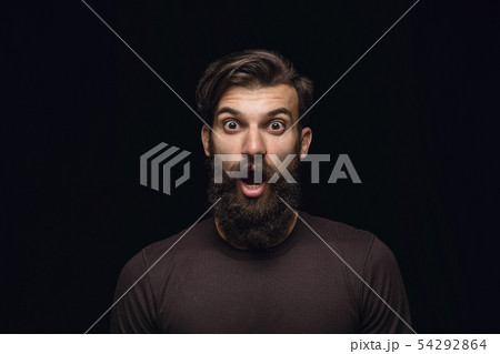 Close up portrait of young man isolated on black studio background 54292864