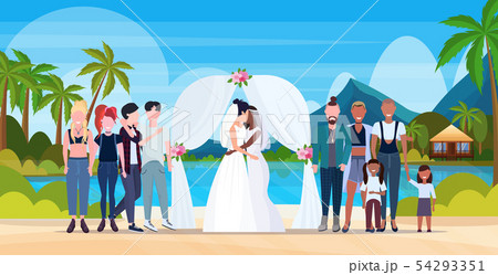 couple newly weds lesbians in white dress standing behind arch same gender married homosexual family 54293351