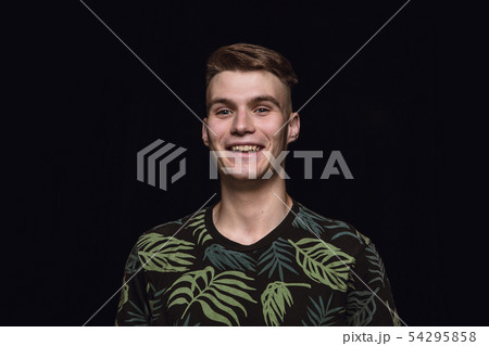 Close up portrait of young man isolated on black studio background Close up portrait of young man isolated on black studio background 54295858