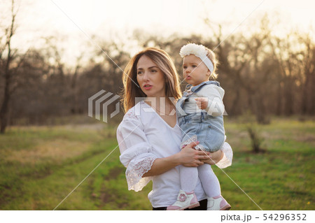 Happy family walks in the spring meadow Happy family walks in the spring meadow 54296352