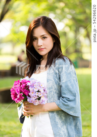 beautiful asian woman with flower in hand 54296620