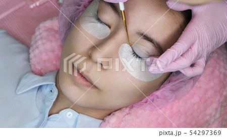 Eyelash Extension Procedure. Woman Eye with Long 54297369