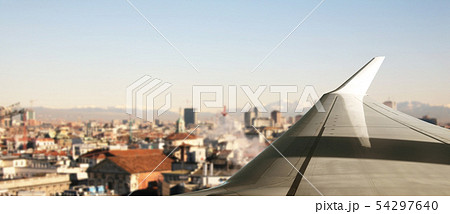 Plane flying over a city 54297640