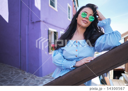tourist woman posing among colorful houses on 54300567