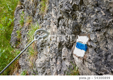 Hiking trail blue paint marking on a rock. 54300899