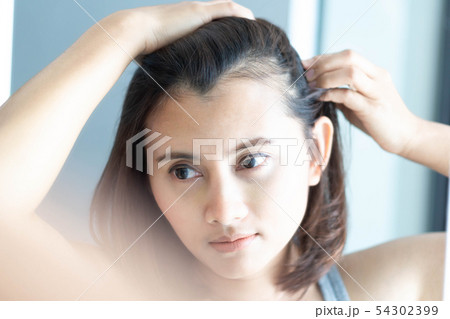 Woman looking reflection in the mirror serious Woman looking reflection in the mirror serious 54302399