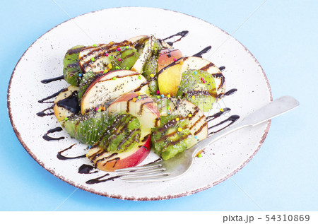 Tasty fruit salad on bright pastel background Tasty fruit salad on bright pastel background 54310869