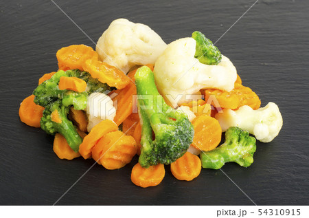 Mix of frozen vegetables on black stone background 54310915