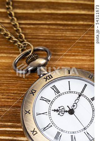 Vintage pocket watch clock on wooden background Vintage pocket watch clock on wooden background 54311673