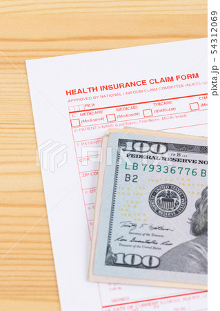 Health insurance claim form on wooden desk Health insurance claim form on wooden desk 54312069