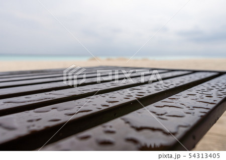 Chair on the beach after a rain 54313405