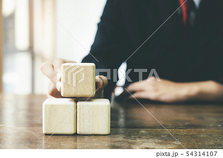 Businessman hand arranging wood block business 54314107