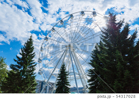 Ferris wheel against blue sky and clouds. Ferris wheel against blue sky and clouds. 54317028