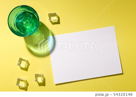 Summer refreshing cocktail with white sheet of paper on yellow Summer refreshing cocktail with white sheet of paper on yellow 54320146