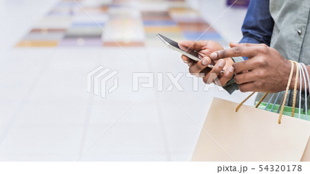 Young african man calling a taxi online on cellphone 54320178