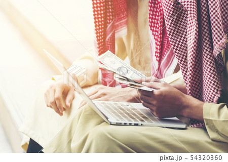 Handsome greedy arab man showing money on hands 54320360