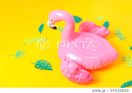 Inflatable pink flamingos on a bright yellow Inflatable pink flamingos on a bright yellow 54320830