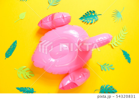 Inflatable pink flamingos on a bright yellow Inflatable pink flamingos on a bright yellow 54320831