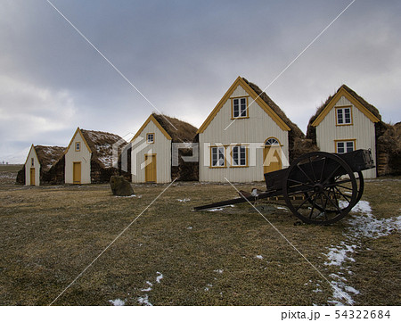 An old carriage in front of the peat houses An old carriage in front of the peat houses 54322684