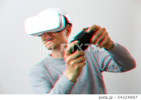 Man with virtual reality headset is playing game. Image with glitch effect. Man with virtual reality headset is playing game. Image with glitch effect. 54324007