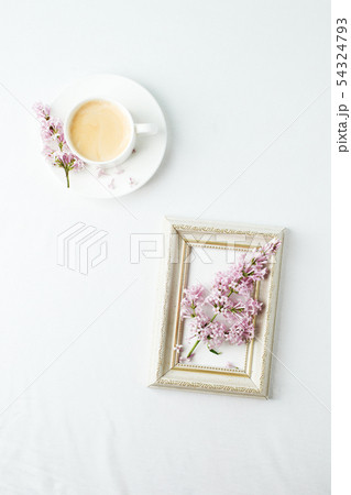 Cup of coffee, lilac branch and frame on white Cup of coffee, lilac branch and frame on white 54324793