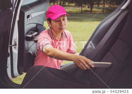 Auto service staff cleaning of interior of the car Auto service staff cleaning of interior of the car 54329423