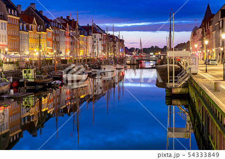 Copenhagen. Nyhavn Canal, colorful houses and city embankment at sunrise. 54333849