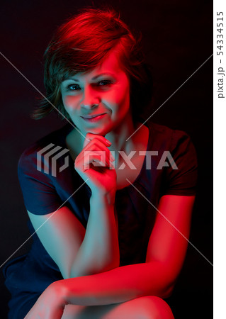 Beautiful attractive young woman posing in neon light in studio 54334515