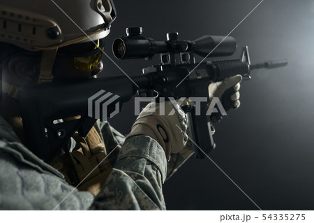 African professional soldier shooting from modern long gun. 54335275