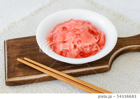 Pickled ginger in a white bowl and chopsticks Pickled ginger in a white bowl and chopsticks 54336683