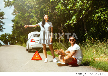 Young couple traveling on the car in sunny day Young couple traveling on the car in sunny day 54342130
