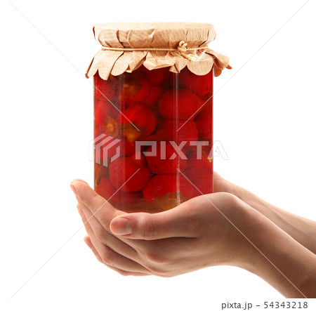 jar of pepper hand held in white background 54343218