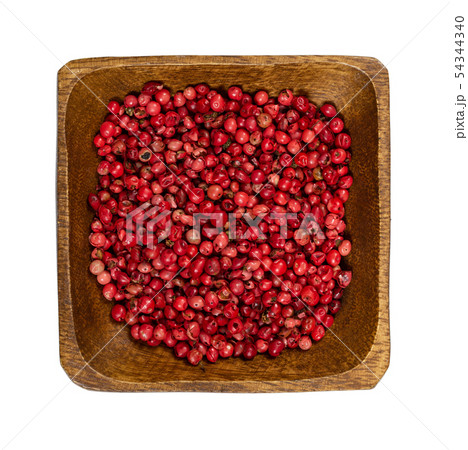 Pink pepper in wooden bowl isolated on white Pink pepper in wooden bowl isolated on white 54344340