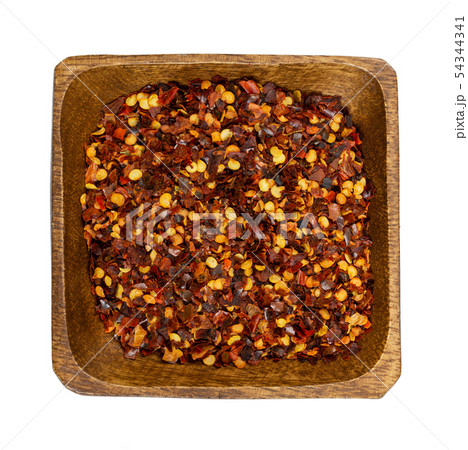 Crushed dried chili peppers in wooden bowl Crushed dried chili peppers in wooden bowl 54344341