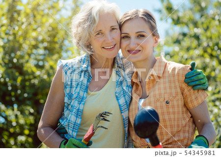 Woman gardening together in summer 54345981