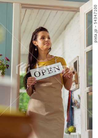 Thoughtful flower shop owner standing in a doorway. Thoughtful flower shop owner standing in a doorway. 54347100