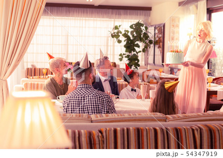 Blonde-haired mommy bringing birthday cake for her boy Blonde-haired mommy bringing birthday cake for her boy 54347919